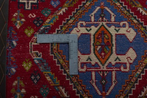 Backside of handmade 2000s Shiraz rug showing knot structure and weave density