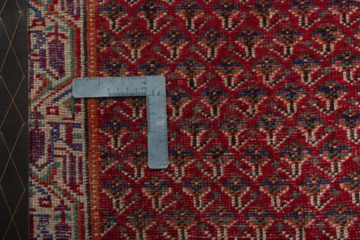 Backside of handmade 2000s Shiraz rug showing knot structure and weave density