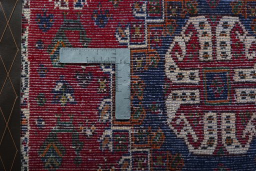 Backside of handmade 2000s Shiraz rug showing knot structure and weave density