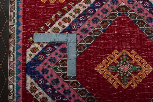 Backside of handmade 2000s Shiraz rug showing knot structure and weave density