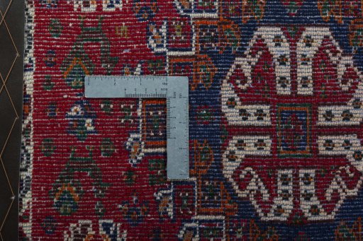 Backside of handmade 2000s Shiraz rug showing knot structure and weave density
