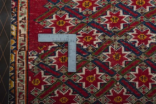 Backside of handmade 2000s Shiraz rug showing knot structure and weave density