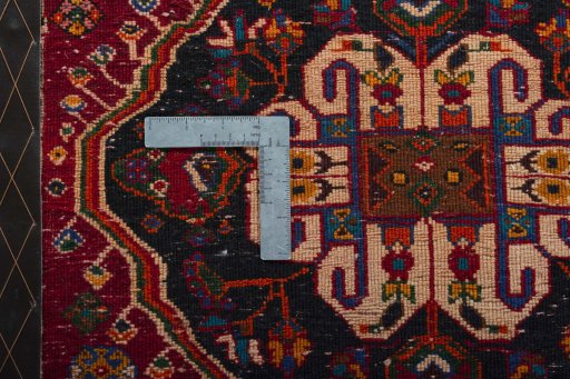 Backside of handmade 2000s Shiraz rug showing knot structure and weave density