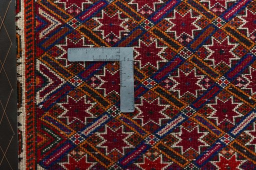 Backside of handmade 2000s Shiraz rug showing knot structure and weave density
