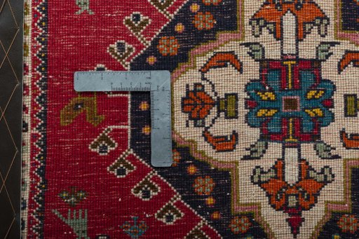 Backside of handmade 2000s Shiraz rug showing knot structure and weave density