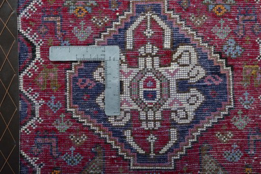 Backside of handmade 2000s Shiraz rug showing knot structure and weave density