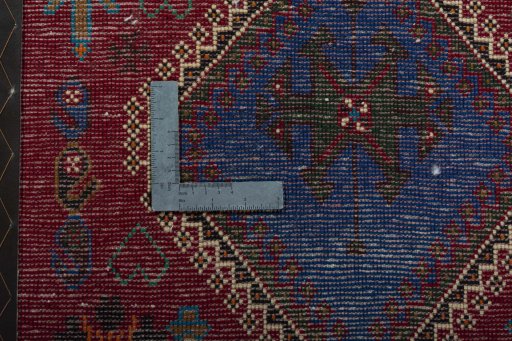 Backside of handmade 2000s Shiraz rug showing knot structure and weave density