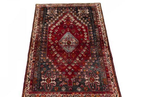 Surface texture of 2000s Shiraz rug with natural Wool and intricate pattern