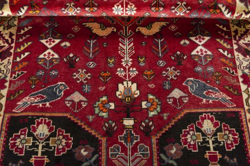 Corner detail of 2000s Shiraz rug showing border pattern and Wool pile