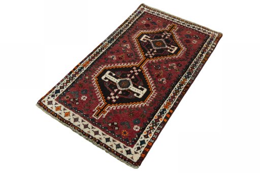 Corner detail of 2000s Shiraz rug showing border pattern and Wool pile