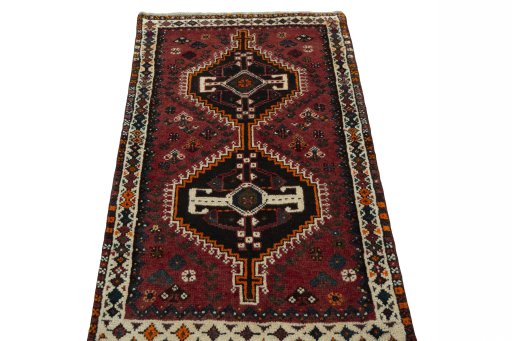 Surface texture of 2000s Shiraz rug with natural Wool and intricate pattern