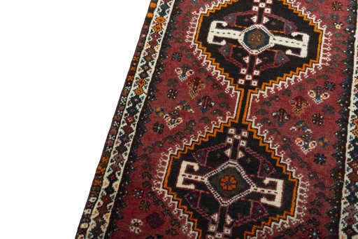 Backside of handmade 2000s Shiraz rug showing knot structure and weave density