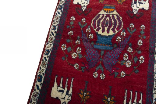 Backside of handmade 2000s Shiraz rug showing knot structure and weave density