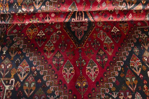 Corner detail of 2000s Shiraz rug showing border pattern and Wool pile