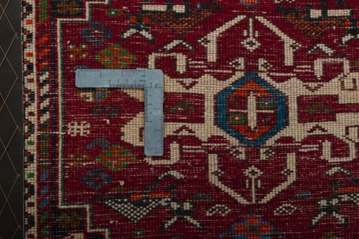 Backside of handmade 2000s Shiraz rug showing knot structure and weave density