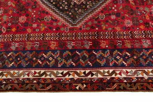 Corner detail of 2000s Shiraz rug showing border pattern and Wool pile