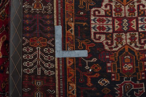 Surface texture of 2000s Shiraz rug with natural Wool and intricate pattern