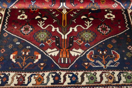 Corner detail of 2000s Shiraz rug showing border pattern and Wool pile