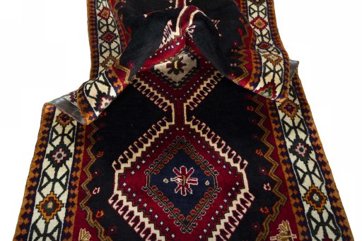 Corner detail of 2000s Shiraz rug showing border pattern and Wool pile