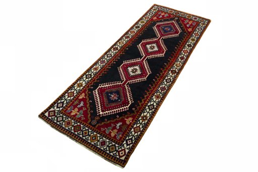 Corner detail of 2000s Shiraz rug showing border pattern and Wool pile