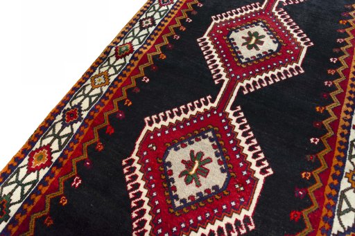 Backside of handmade 2000s Shiraz rug showing knot structure and weave density