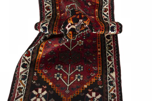 Corner detail of 2000s Shiraz rug showing border pattern and Wool pile