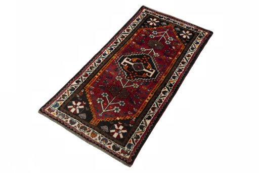 Corner detail of 2000s Shiraz rug showing border pattern and Wool pile