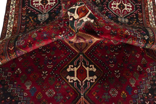 Corner detail of 2000s Shiraz rug showing border pattern and Wool pile
