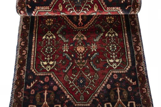 Corner detail of 2000s Shiraz rug showing border pattern and Wool pile