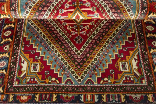 Corner detail of 2000s Shiraz rug showing border pattern and Wool pile