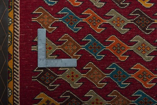 Backside of handmade 2000s Shiraz rug showing knot structure and weave density