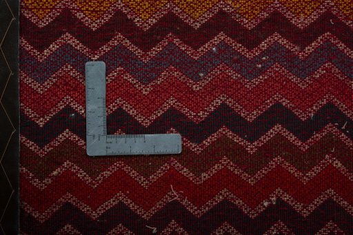 Backside of handmade 2000s Shiraz rug showing knot structure and weave density