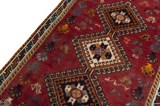 Backside of handmade 2000s Shiraz rug showing knot structure and weave density