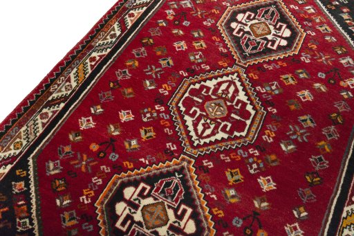 Backside of handmade 2000s Shiraz rug showing knot structure and weave density