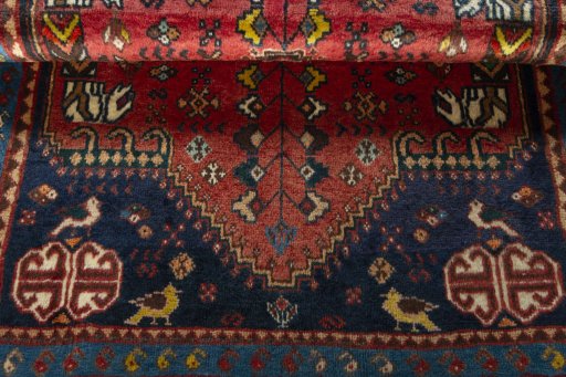 Corner detail of 2000s Shiraz rug showing border pattern and Wool pile
