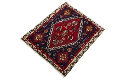 Corner detail of 2000s Shiraz rug showing border pattern and Wool pile
