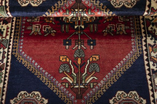 Corner detail of 2000s Shiraz rug showing border pattern and Wool pile