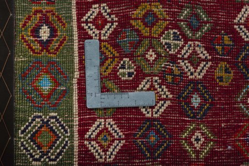 Backside of handmade 2000s Shiraz rug showing knot structure and weave density