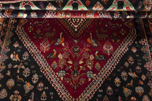 Corner detail of 2000s Shiraz rug showing border pattern and Wool pile