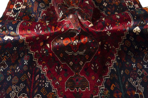 Corner detail of 2000s Shiraz rug showing border pattern and Wool pile