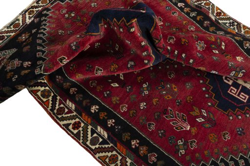 Corner detail of 2000s Shiraz rug showing border pattern and Wool pile