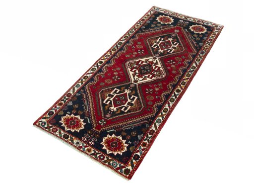 Corner detail of 2000s Shiraz rug showing border pattern and Wool pile