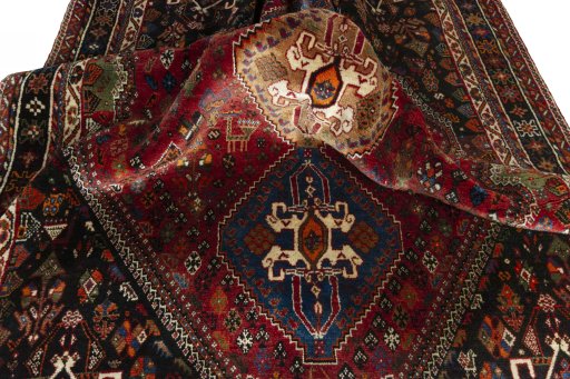 Corner detail of 2000s Shiraz rug showing border pattern and Wool pile