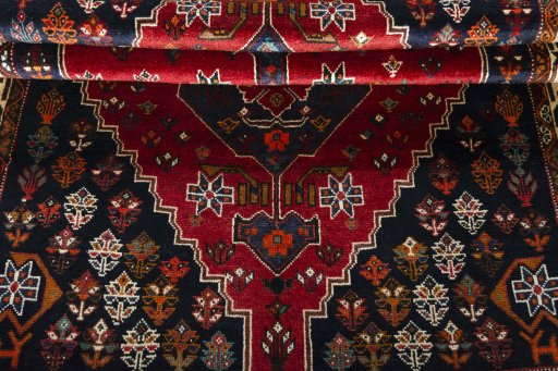 Corner detail of 2000s Shiraz rug showing border pattern and Wool pile