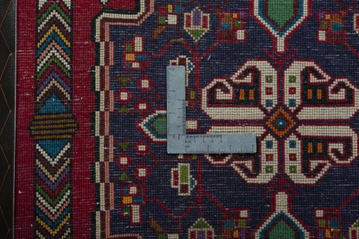 Backside of handmade 2000s Shiraz rug showing knot structure and weave density