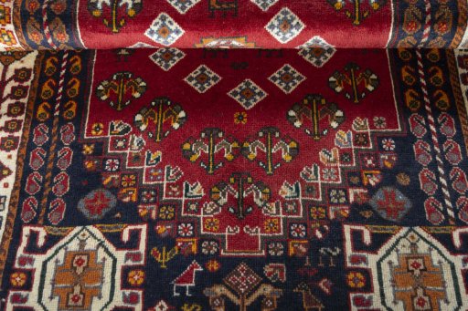 Corner detail of 2000s Shiraz rug showing border pattern and Wool pile