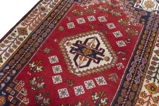 Backside of handmade 2000s Shiraz rug showing knot structure and weave density