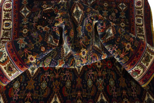 Corner detail of 2000s Shiraz rug showing border pattern and Wool pile