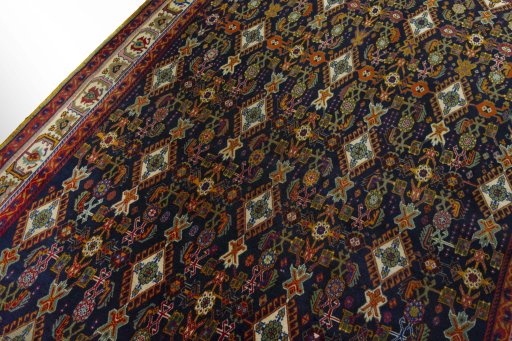 Backside of handmade 2000s Shiraz rug showing knot structure and weave density
