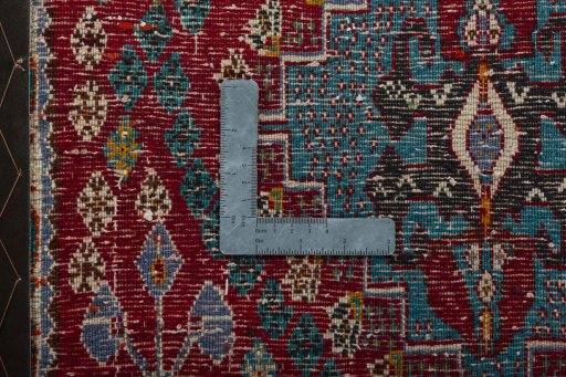 Backside of handmade 2000s Shiraz rug showing knot structure and weave density